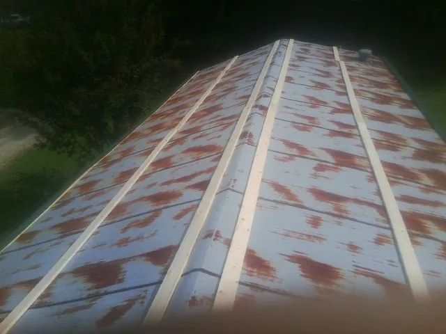 Rusted metal roof panels with new wood purlins before replacement — Storm Damage Roof Repair in Albrightsville by Roofing Brothers
