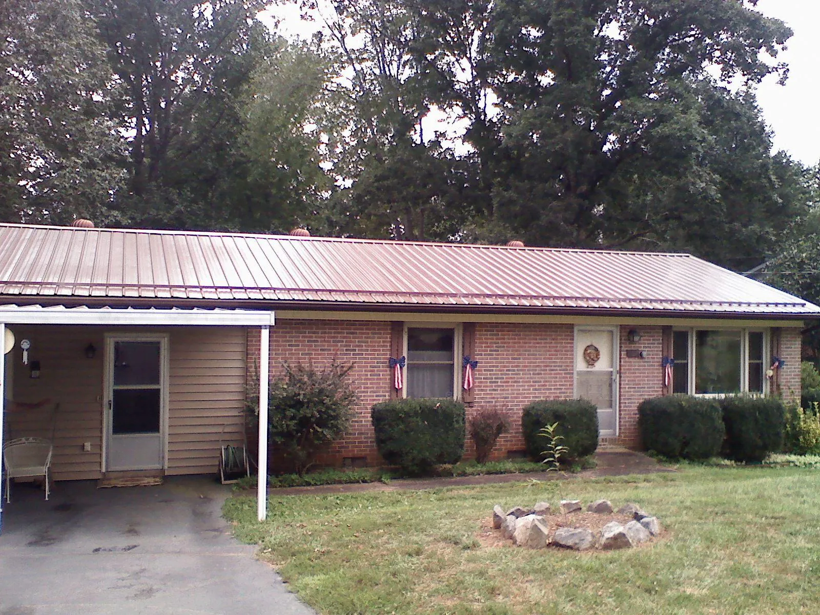 Bronze metal roof and carport on a brick ranch home — Roof Repair work by our crew in Albrightsville